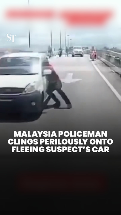 Malaysia policeman clings onto fleeing suspect’s car